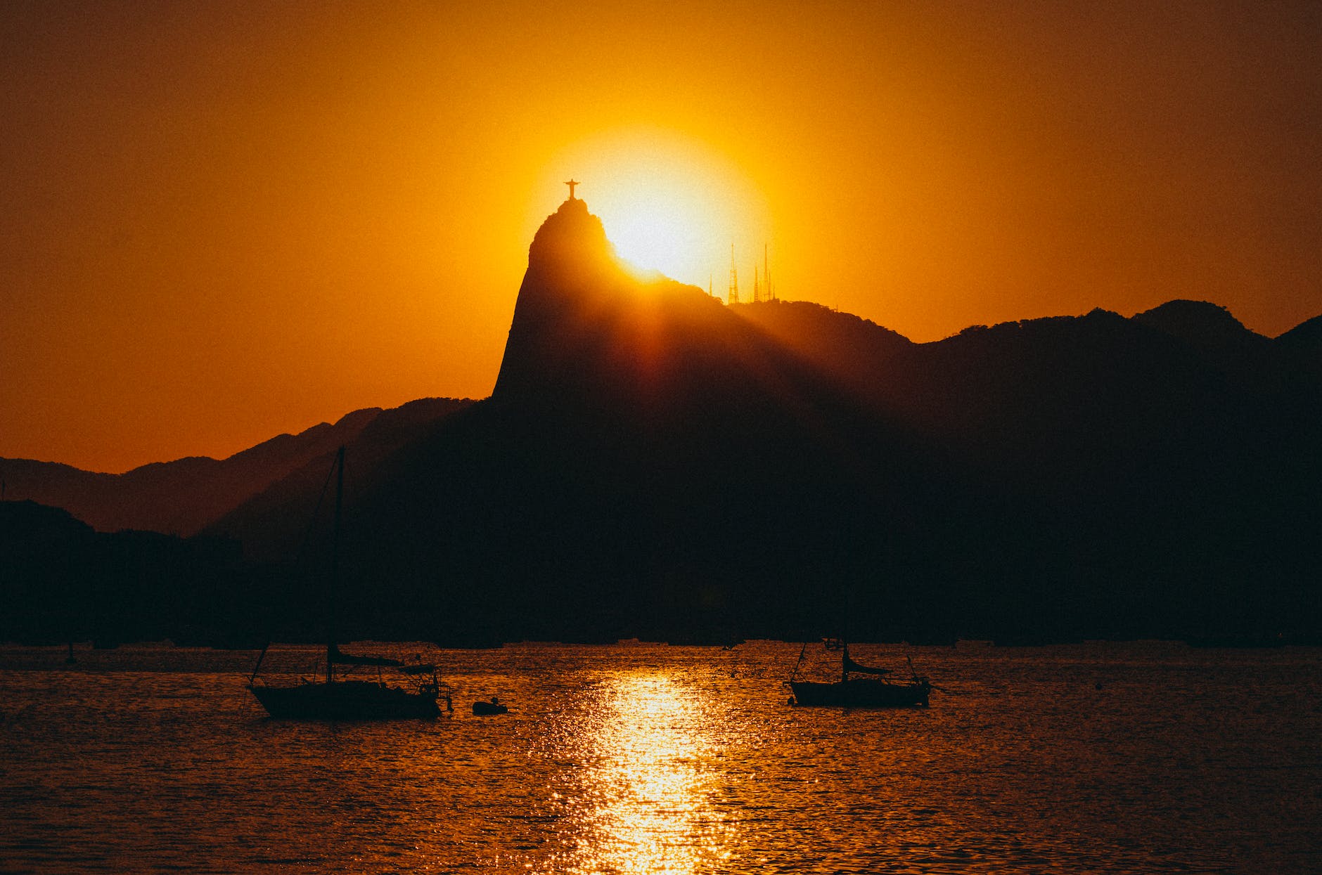 silhouette of two boats on body of water